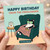 Funny Cat Birthday Card - Happy Birthday From The Freeloader | Lounging Cat with Cucumber Eye Pads, Snack Bowl and Remote - For Friends, Family and Lovers