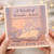 World Book Day Card - 'A World of Wonder Awaits' - Cosy Window Scene with Open Book, Doves and Teacup - For Readers, Teachers and Lovers