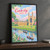 Cambridge, England travel poster full-bleed print styled in Black frame / charcoal wall; frame and props not included