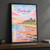 Bamburgh, England travel poster full-bleed print styled in Black frame / charcoal wall; frame and props not included