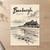 Bamburgh, England travel poster full-bleed print styled in Unframed sheet - corrected A-series; frame and props not included