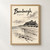 Bamburgh, England travel poster full-bleed print styled in Front oak frame - corrected opening; frame and props not included