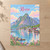 Reine, Norway travel poster full-bleed print styled in Unframed sheet - corrected A-series; frame and props not included
