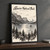 Glacier National Park St Mary Lake Wild Goose Island full-bleed print styled in Black frame / charcoal wall; frame and props not included