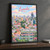 Luanda city view full-bleed print styled in Black frame / charcoal wall; frame and props not included