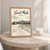 Saint-Malo ramparts from the beach full-bleed print styled in Oak frame / bedside table; frame and props not included