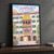 Innsbruck Golden Roof full-bleed print styled in Black frame / charcoal wall; frame and props not included