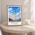 Bouaké city view bordered print styled in Oak frame / bedside table; frame and props not included