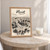 Herāt city view full-bleed print styled in Oak frame / bedside table; frame and props not included