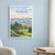 Auckland city view full-bleed print styled in White frame / blue sitting room; frame and props not included