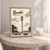 Bouaké city view full-bleed print styled in Oak frame / bedside table; frame and props not included