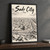 Sadr City city view full-bleed print styled in Black frame / charcoal wall; frame and props not included