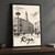 Riga city view full-bleed print styled in Black frame / charcoal wall; frame and props not included