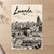 Luanda city view full-bleed print styled in Unframed sheet - corrected A-series; frame and props not included