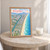 Barra da Tijuca city view full-bleed print styled in Oak frame / bedside table; frame and props not included