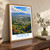 Tuxtla city view bordered print styled in Original angled oak-console; frame and props not included
