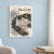 Cana Island Lighthouse full-bleed print styled in White frame / blue sitting room; frame and props not included