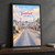 Diepsloot city view full-bleed print styled in Black frame / charcoal wall; frame and props not included