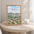 Betim city view full-bleed print styled in Oak frame / bedside table; frame and props not included