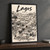 Lagos city view full-bleed print styled in Black frame / charcoal wall; frame and props not included