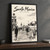 Los Angeles Santa Monica Pier full-bleed print styled in Black frame / charcoal wall; frame and props not included