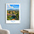 Pécs city view bordered print styled in White frame / blue sitting room; frame and props not included