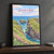 Carrick-a-Rede rope bridge full-bleed print styled in Black frame / charcoal wall; frame and props not included
