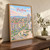 Pristina city view full-bleed print styled in Original angled oak-console; frame and props not included