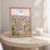 Ibb city view full-bleed print styled in Oak frame / bedside table; frame and props not included
