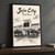 Jeju City city view full-bleed print styled in Black frame / charcoal wall; frame and props not included