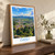 Danlí city view bordered print styled in Original angled oak-console; frame and props not included