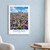 Amiens city view bordered print styled in White frame / blue sitting room; frame and props not included