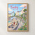 Tenby harbour pastel houses full-bleed print styled in Front oak frame - corrected opening; frame and props not included