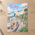 Tenby harbour pastel houses full-bleed print styled in Unframed sheet - corrected A-series; frame and props not included