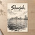 Sharjah city view full-bleed print styled in Unframed sheet - corrected A-series; frame and props not included