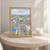 Akure city view full-bleed print styled in Oak frame / bedside table; frame and props not included