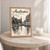 Amsterdam city view full-bleed print styled in Oak frame / bedside table; frame and props not included