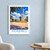 Huambo city view bordered print styled in White frame / blue sitting room; frame and props not included
