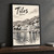 Tilos full-bleed print styled in Black frame / charcoal wall; frame and props not included