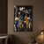 Cluster of clear, cobalt and amber glass vessels holding pale flowers and leafy stems on a reflective surface against a dark background.; frame shown for styling only