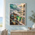 Turquoise-green wave breaking across a rocky sunset shoreline scattered with colored sea glass, including a large green fragment in the foreground.; frame shown for styling only