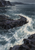 Pale surf sweeps around dark rock shelves in a cool-toned, painterly coastal basin.