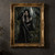Black-haired crowned woman with tattoos sits among moss-covered ruins between two ravens.; frame shown for styling only