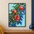 Three red pomegranates on a diagonal leafy branch, with the lower fruit split to show ruby seeds against an aqua and blue background.; frame shown for styling only