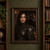 Dark-haired woman in weathered dark armor with a large black raven close beside her face.; frame shown for styling only