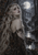 Pale pointed-eared woman with silver-blond hair and dark leaf adornments before a full moon, ruined arches, and reflective water.