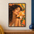 Close portrait of an adult woman with closed eyes leaning against a large orange-and-cream blossom amid dark curls and green leaves.; frame shown for styling only