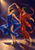 Two dancers in cobalt and vermilion costumes turn together beneath a warm spotlight on a dark stage.