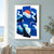 Coral-orange sun partly hidden by a pale wave band among irregular cobalt and ultramarine collage panels.; frame shown for styling only