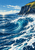 Large cobalt wave curling with white foam in front of a tall dark coastal cliff topped with bright grass beneath a blue sky.